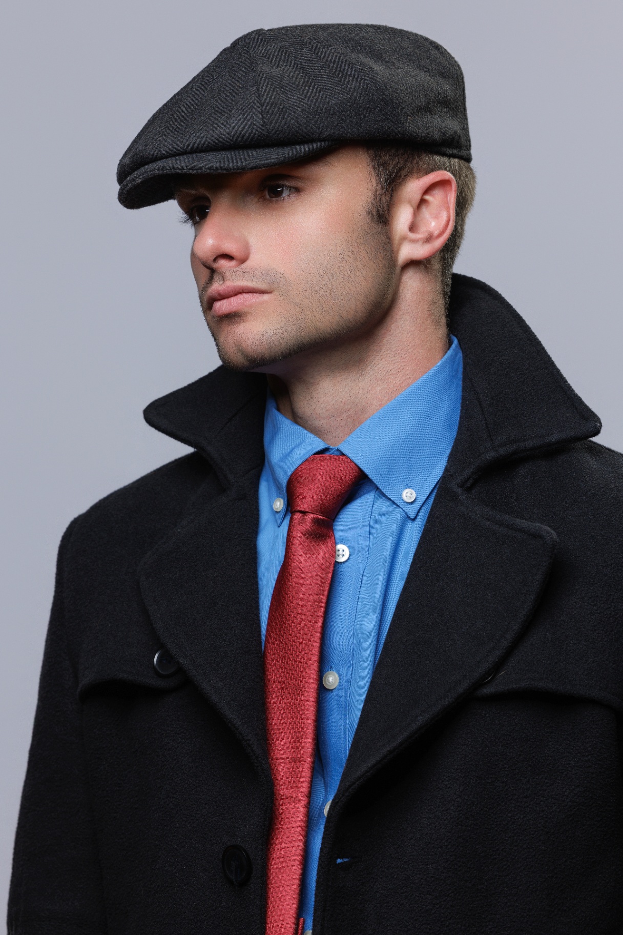Editorial portrait in flat cap and overcoat