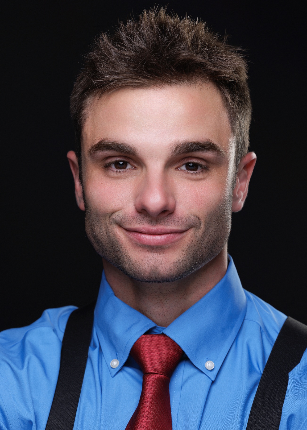 Studio headshot with blue shirt and red tie