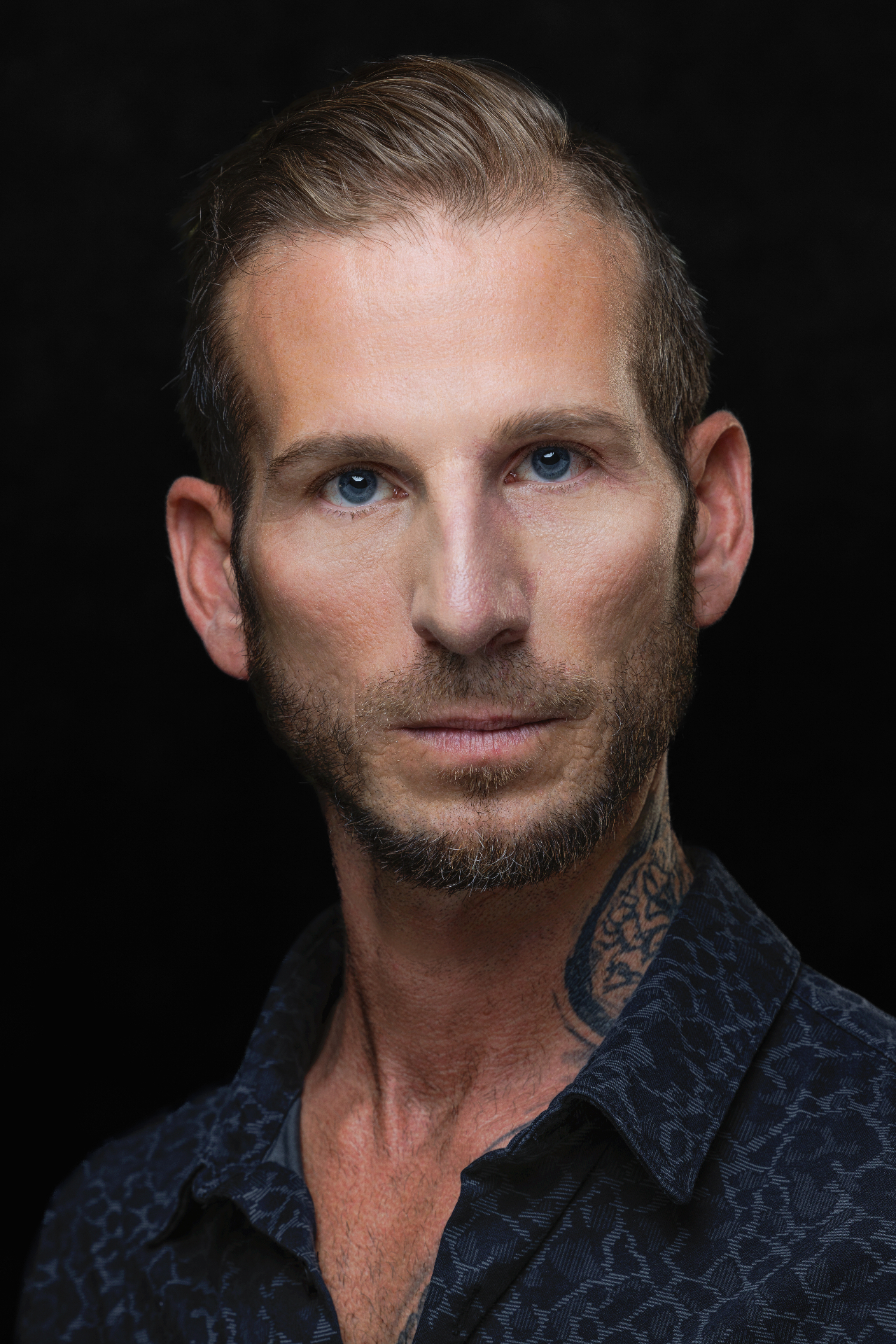 Editorial portrait with blue eyes and patterned shirt